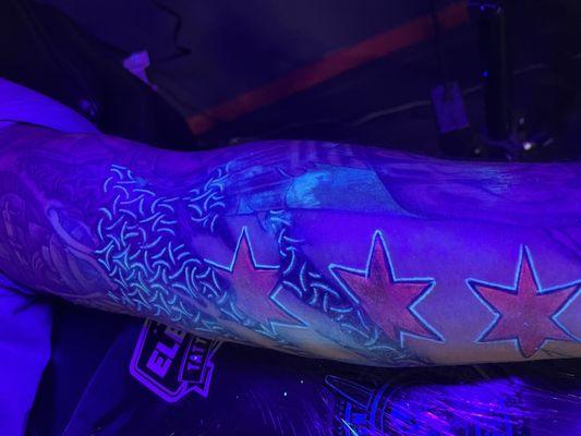 Tattoo artist Hevs using UV ink on his client. Freaking cool!