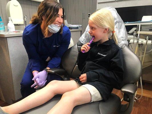 One of our assistants, Mackenzie teaching a patient the proper way of brushing!