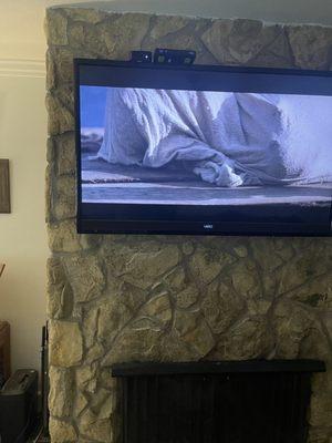 Tv mounted over fireplace