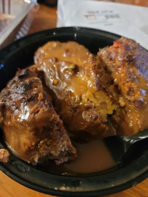 Meatloaf soaked in brown gravy sauce.