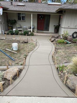 Smooth broom-finish curved walkway with borders and bands.