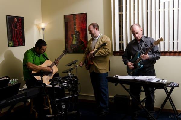 Robert and Ray working with Eric, master guitar instructor.