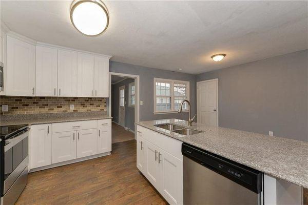 White Shaker cabinets from Global Home Decor. Bainbrook Brown granite installed by Global Home Decor.