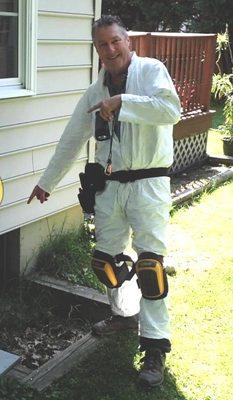 Entering a crawlspace during a home inspection.