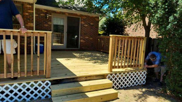 Deck after it was put back together. New lattice deck boards and handrails.