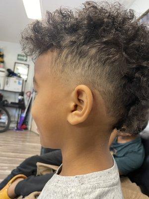 My 7 y/old, long Mohawk with fade, curly hair, mixed kid.