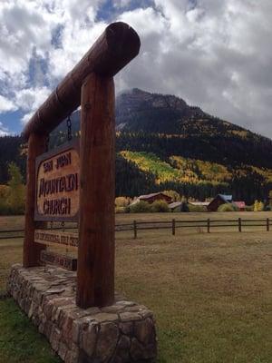 Church sign out front in the fall.