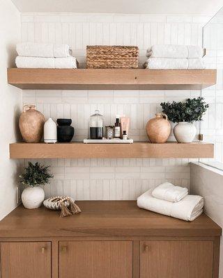 Carefully crafted custom floating white oak shelves with matching custom built-in vanity.