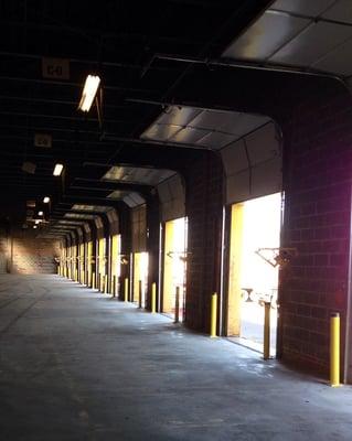 New sectional garage doors installed in a warehouse.