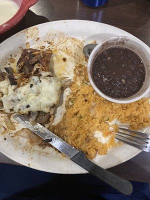 Supposed to be a UN SEASONED Rib-eye covered with mushrooms and onions and cheese- mushy rice and UNSEASONED black beans-