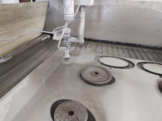 Sheet Metal Fabrication. Water Jet Cutting an oval shaped part.