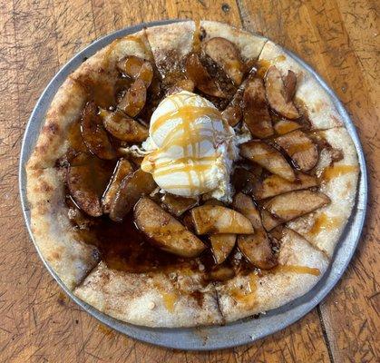 Our "Holy Crapple Pie". A dessert pizza covered in a blend of cinnamon, brown sugar, sauteed apple and oats. Ice cream and caramel topping!