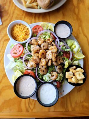 Top: Crab Cake Po-boy Bottom: Grilled shrimp salad with cajun ranch dressing