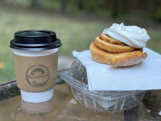 Vanilla oat milk latte and a fresh baked cinnamon roll