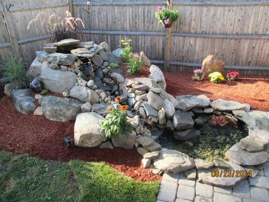 Back yard water feature Stone water fall designed and installed by Birmingham Landscape construction.