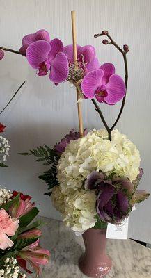 Lavender Beauty fresh cut hydrangeas, greenery, and a beautiful purple orchid.