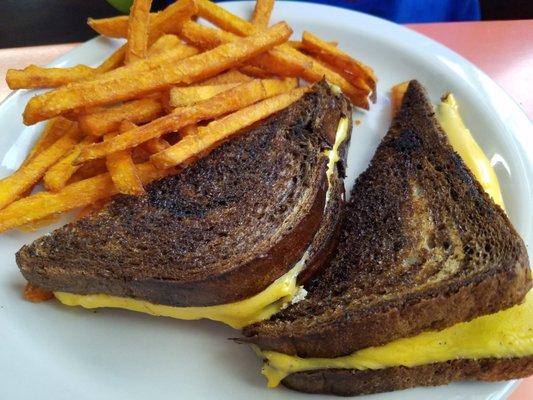 Grilled cheese on dark rye with sweet potato fries.