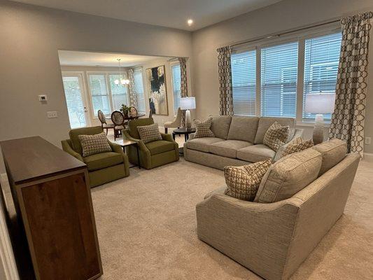 Zachary designed this family room with new drapes, sofa, chairs, pillows, lamps and banquette.