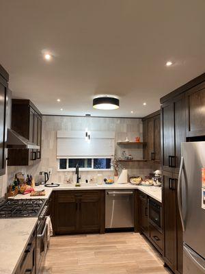 New light fixture and recessed lights in kitchen.