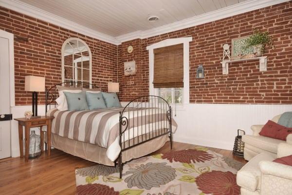 The quaint & cozy Hideaway has the original brick walls & a claw foot tub. All guests rooms feature the ambiance of an electric fireplace.