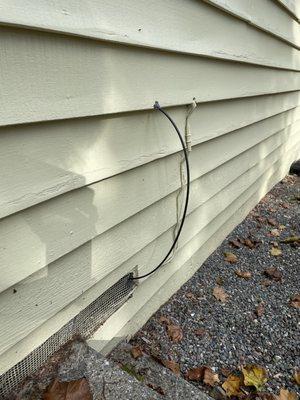 Ziply's installation leaving my crawlspace vent, looping out and back in to where my router is.