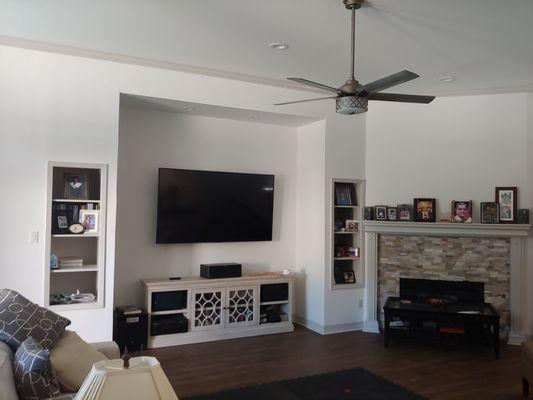 Finished remodel of fireplace, wood look tile, and entertainment area