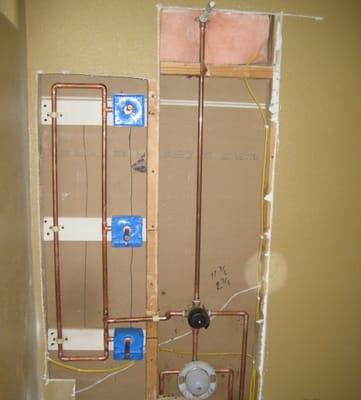 Rough plumbing for a shower with multiple body heads sprayers.