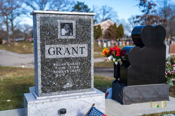 William E. Grant's grey cemetery headstone during the day.