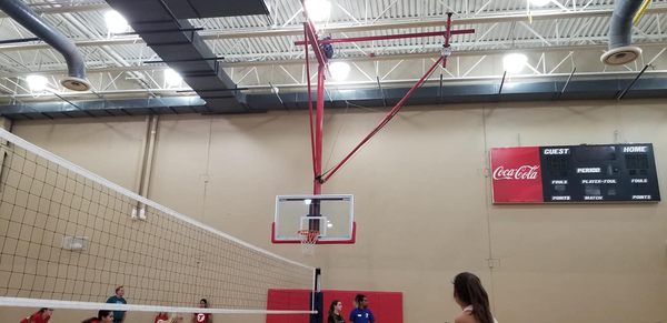 one of the basketball hoops, down during a volleyball game.