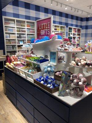 Bath bomb display and soaps in the back of the store.