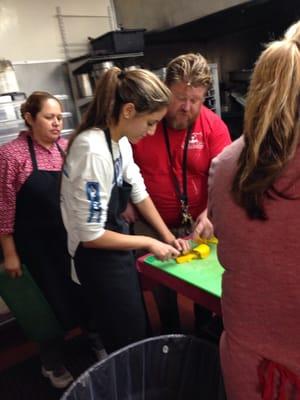 Craig teaching the volunteers how to chop the veggies for the meal of the day