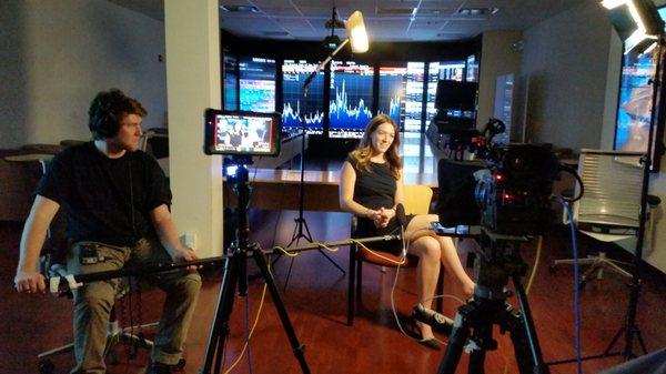 Corporate interview with 8 Vertical 100in Monitors for background.