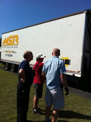 Suzanne from Team Q&A working with the load-in of the stage for a festival in Piedmont Park.