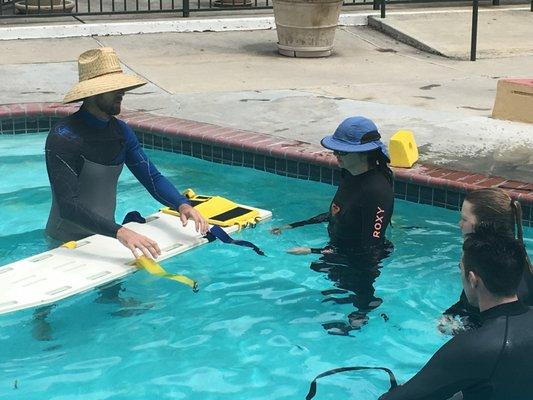 A Lifeguard Instructor Training Course. Our teacher mike showing spinal board procedures. Our teacher Katie hiding from the sun.