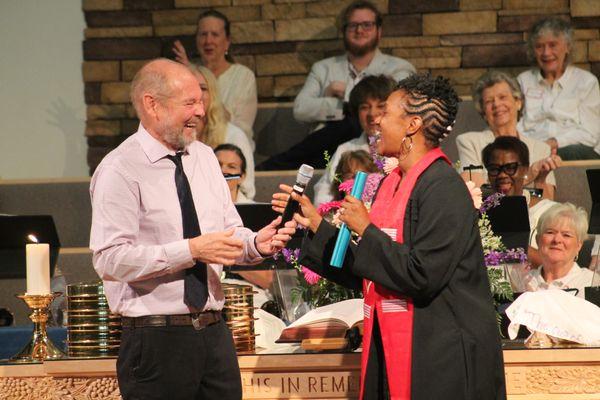 Pastor David passes the baton to Pastor Sharon.