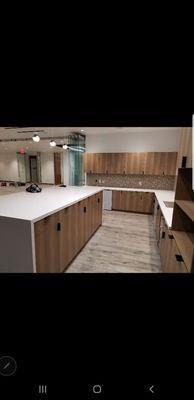 Quartz countertops. Mosaic tile backsplash. Plank tile floor