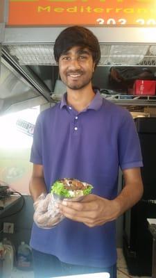 Asi (pronounced Ah- Sigh) proudly shows a gyro wrap