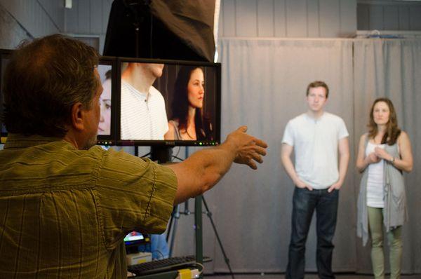 Students being instructed while filming a scene in the studio