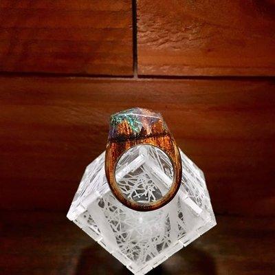 A selection of handcrafted resin and imported exotic hardwood rings.