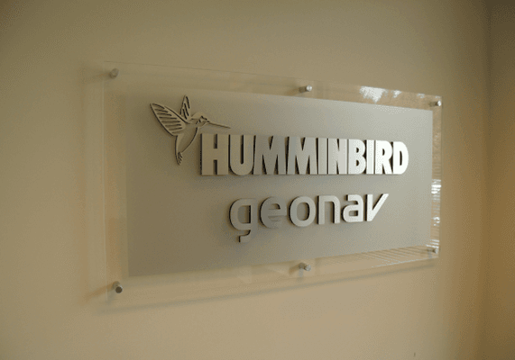 This lobby sign features clear acrylic with frosted vinyl application on back, with contour dimensional brushed aluminum letters applied.