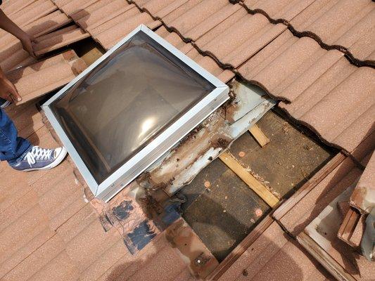 Pulling up a skylight that was causing leaks on a decree roof