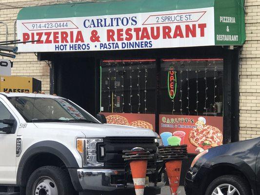 Outside storefront.   Inside:  Calzone-- with pepperoni.