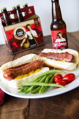 Grand Champion Meats brats on a plate with Lift Bridge Beer.