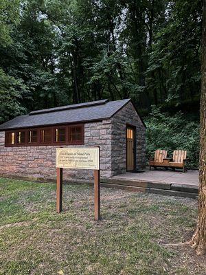 Outside a camping cabin, located in the midst of campsites.