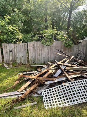 Pile of wood from a deck being hauled away.