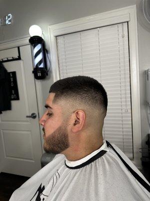 Mid-high bald fade with beard line up