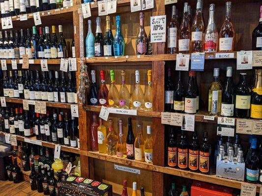 Wall of wine at the front of the shop. (also more adjacent to the register and some bottles in the cooler.)