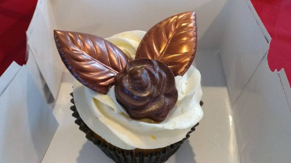 Jumbo cupcake with chocolate rose and leaves.