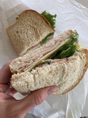 Deli sandwich with sourdough, turkey, Swiss, lettuce, Mayo, tomato