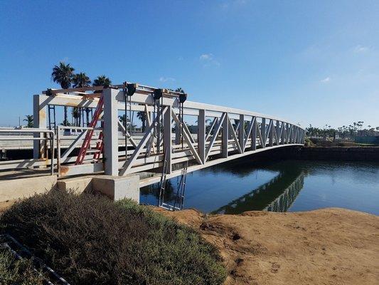 Sandblast and paint the bridge. Building specialized scaffold.